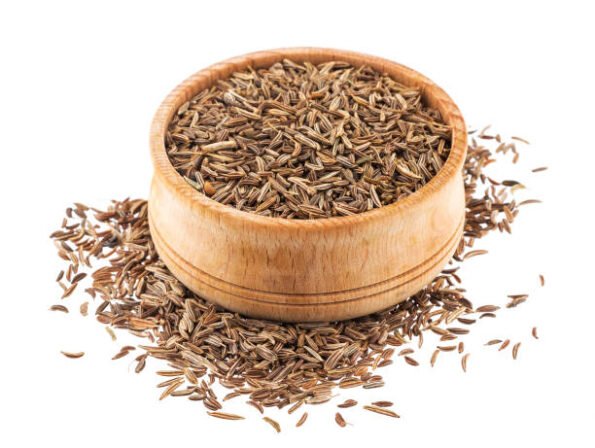 Cumin or caraway seeds in wooden bowl isolated on white background